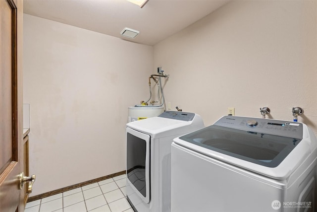 14413 139th Ave SE, Snohomish, WA 98290 - laundry room featuring washing machine and clothes dryer, baseboards, light tile patterned flooring, and water heater