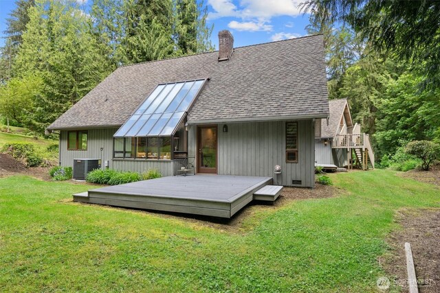 14413 139th Ave SE, Snohomish, WA 98290 - back of property featuring a shingled roof, a lawn, a chimney, and central AC unit
