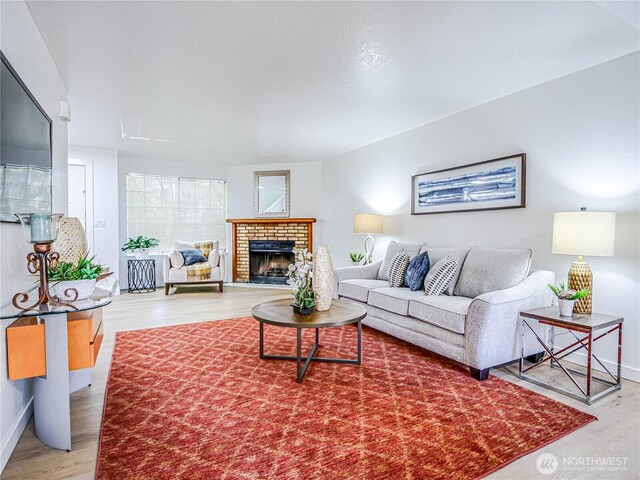 8407 18th Ave W Unit 4-102, Everett, WA 98204 - living room featuring wood finished floors, a fireplace, and baseboards