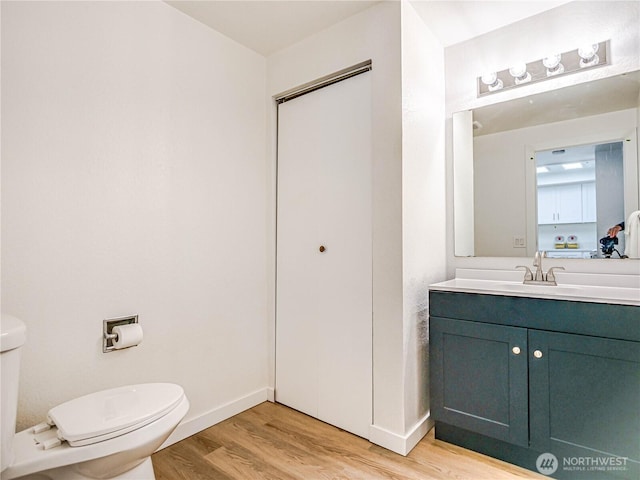 8407 18th Ave W Unit 4-102, Everett, WA 98204 - half bathroom with toilet, wood finished floors, baseboards, and vanity