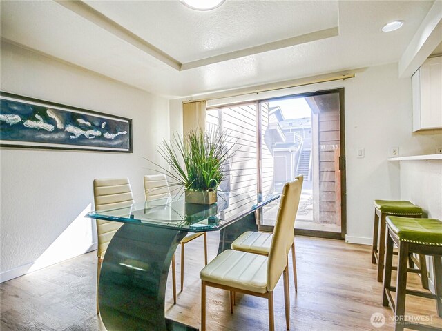 8407 18th Ave W Unit 4-102, Everett, WA 98204 - dining room featuring baseboards, a raised ceiling, and light wood finished floors