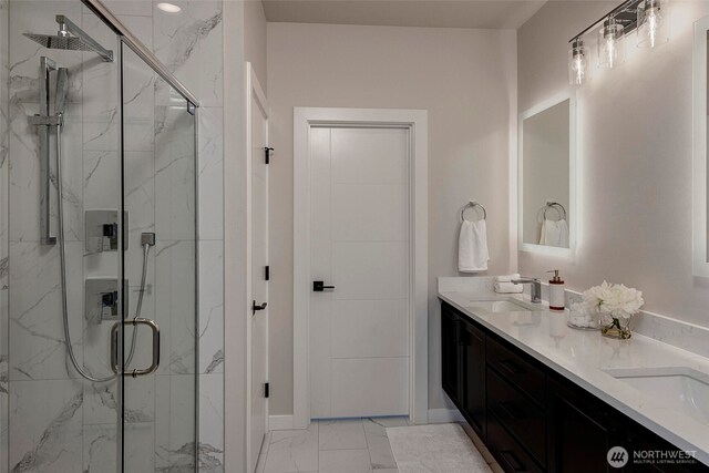16215 Simonds Rd NE Unit 3, Kenmore, WA 98028 - bathroom with marble look tiles, a marble finish shower, baseboards, and double vanity