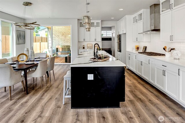 16215 Simonds Rd NE Unit 3, Kenmore, WA 98028 - kitchen with wall chimney range hood, stainless steel appliances, a chandelier, backsplash, and recessed lighting