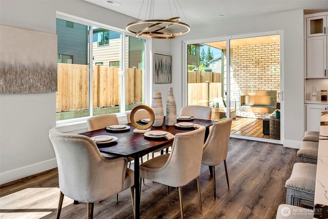 16215 Simonds Rd NE Unit 3, Kenmore, WA 98028 - dining space with baseboards, a chandelier, healthy amount of natural light, and dark wood-style floors
