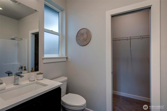 16215 Simonds Rd NE Unit 3, Kenmore, WA 98028 - full bath featuring toilet, vanity, a shower, a walk in closet, and baseboards
