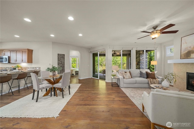 14419 190th Avenue Ct E, Bonney Lake, WA 98391 - living room featuring recessed lighting, a tile fireplace, dark wood finished floors, ceiling fan, and baseboards