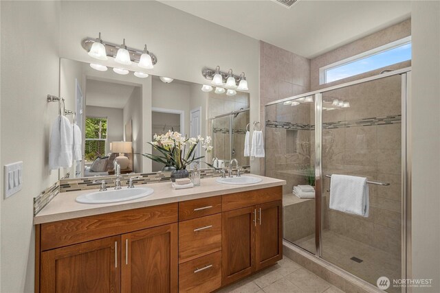 14419 190th Avenue Ct E, Bonney Lake, WA 98391 - ensuite bathroom featuring a stall shower, double vanity, and tile patterned floors
