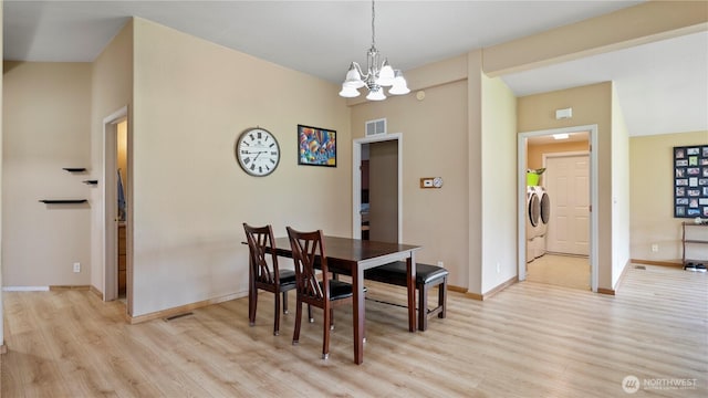 10615 SE Handicap Dr, Warden, WA 98857 - dining area with light wood finished floors, a chandelier, baseboards, and independent washer and dryer