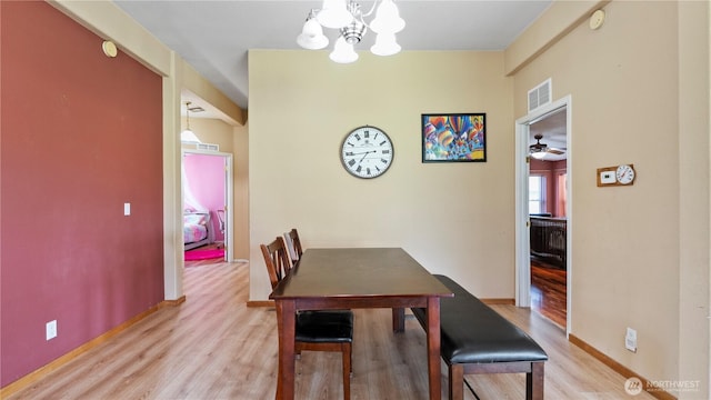 10615 SE Handicap Dr, Warden, WA 98857 - dining space featuring a chandelier, wood finished floors, baseboards, and ceiling fan