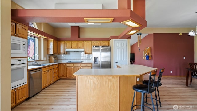 10615 SE Handicap Dr, Warden, WA 98857 - kitchen featuring appliances with stainless steel finishes, a sink, light wood-type flooring, and light countertops