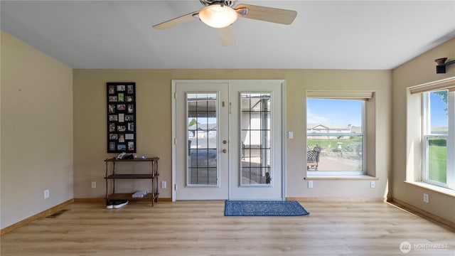 10615 SE Handicap Dr, Warden, WA 98857 - doorway to outside with french doors, wood finished floors, baseboards, and ceiling fan