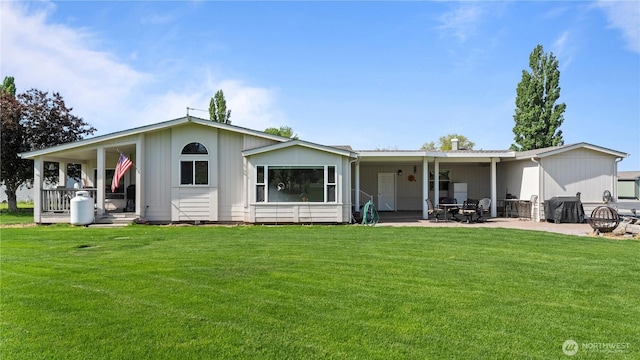 10615 SE Handicap Dr, Warden, WA 98857 - back of property with a lawn, a patio, and covered porch