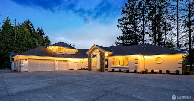 12805 Ruggs Lake Rd, Everett, WA 98208 - view of front of home featuring driveway, a garage, and stucco siding