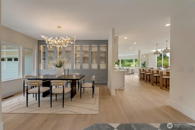 12805 Ruggs Lake Rd, Everett, WA 98208 - dining area featuring light wood-style flooring, a chandelier, recessed lighting, and baseboards