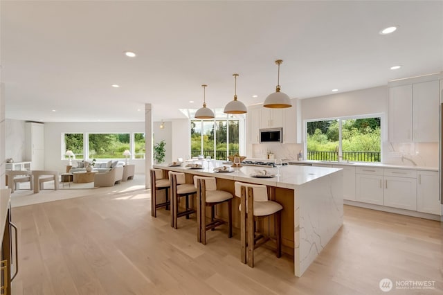 12805 Ruggs Lake Rd, Everett, WA 98208 - kitchen featuring built in microwave, recessed lighting, white cabinetry, and plenty of natural light