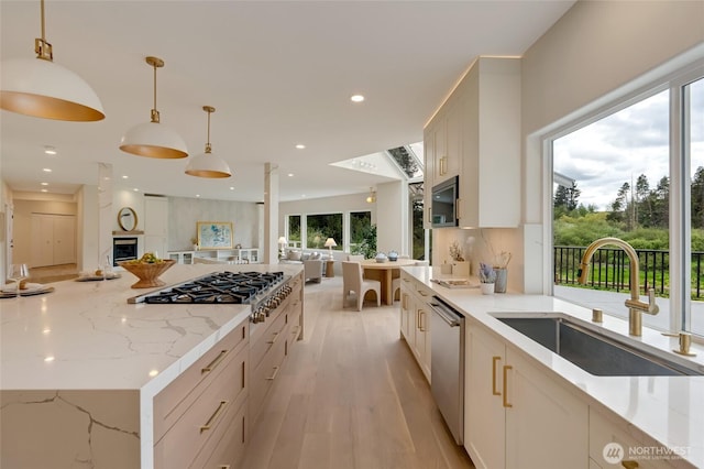 12805 Ruggs Lake Rd, Everett, WA 98208 - kitchen featuring open floor plan, a sink, appliances with stainless steel finishes, light stone counters, and pendant lighting