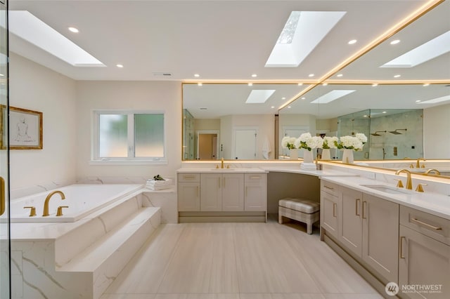 12805 Ruggs Lake Rd, Everett, WA 98208 - full bath featuring a skylight, a marble finish shower, a bath, two vanities, and recessed lighting