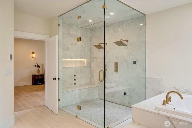 12805 Ruggs Lake Rd, Everett, WA 98208 - bathroom featuring a garden tub, a shower stall, wood finished floors, recessed lighting, and baseboards