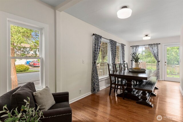 dining space featuring wood finished floors and baseboards