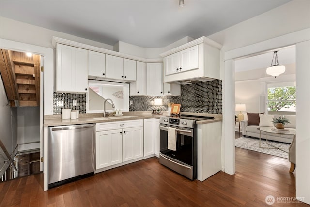 kitchen featuring stainless steel appliances, a sink, white cabinetry, and dark wood-style flooring