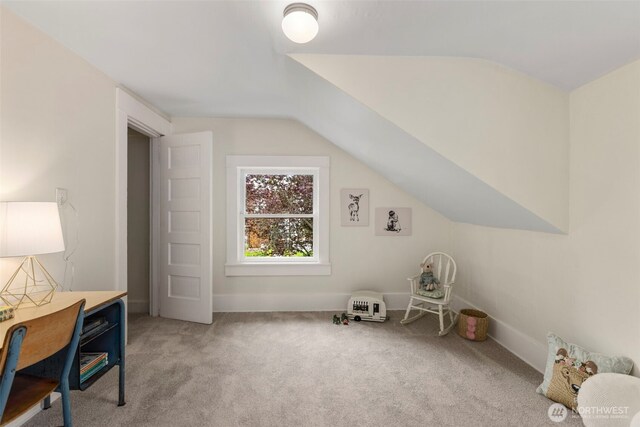 bonus room featuring light colored carpet, vaulted ceiling, and baseboards