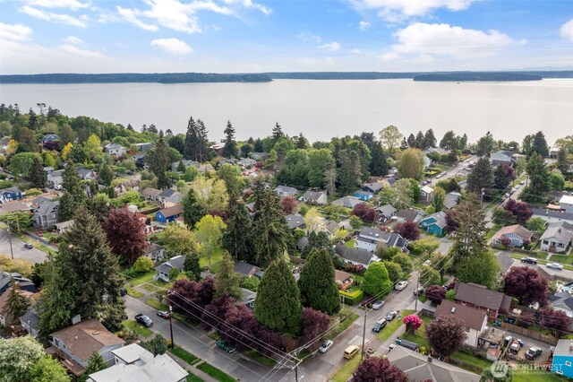 aerial view of residential area featuring a nearby body of water