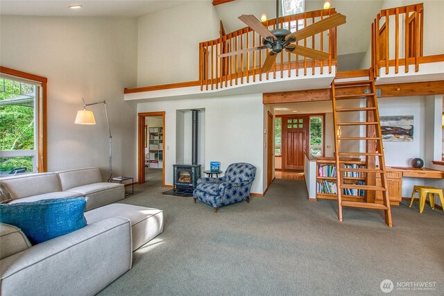 91 Coastline Dr, Orcas Island, WA 98279 - living area featuring carpet, a wood stove, high vaulted ceiling, a ceiling fan, and recessed lighting