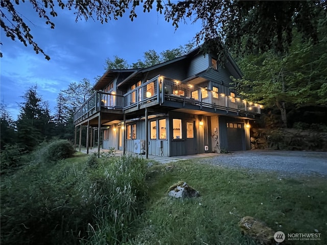 91 Coastline Dr, Orcas Island, WA 98279 - back of property with dirt driveway, board and batten siding, and a wooden deck