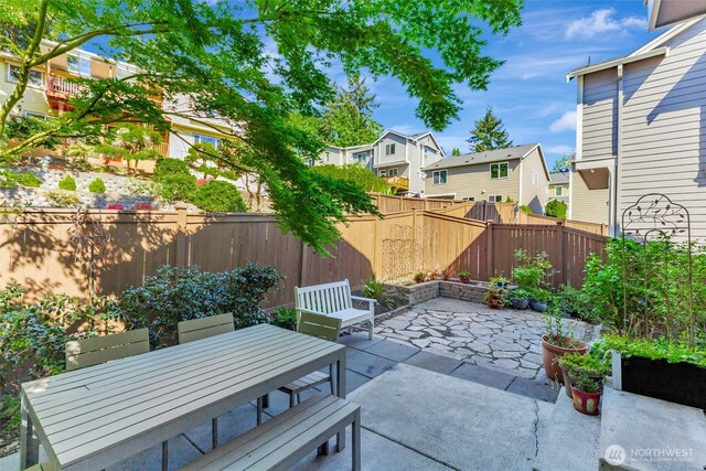 9831 NE 138th Pl, Kirkland, WA 98034 - view of patio with a residential view, a fenced backyard, and outdoor dining space