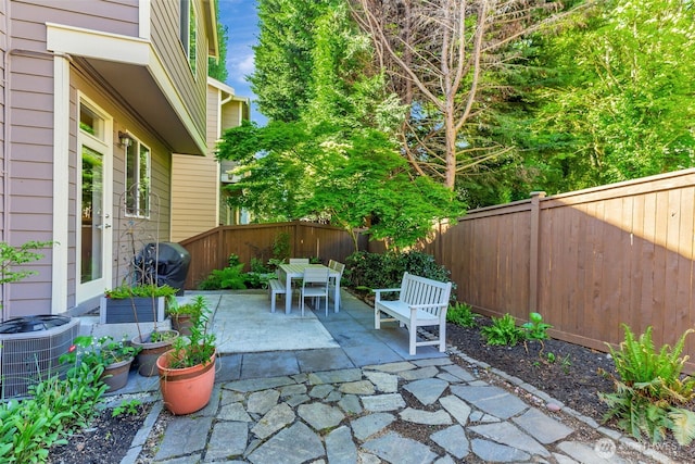 9831 NE 138th Pl, Kirkland, WA 98034 - view of patio featuring central AC, a fenced backyard, outdoor dining area, and area for grilling