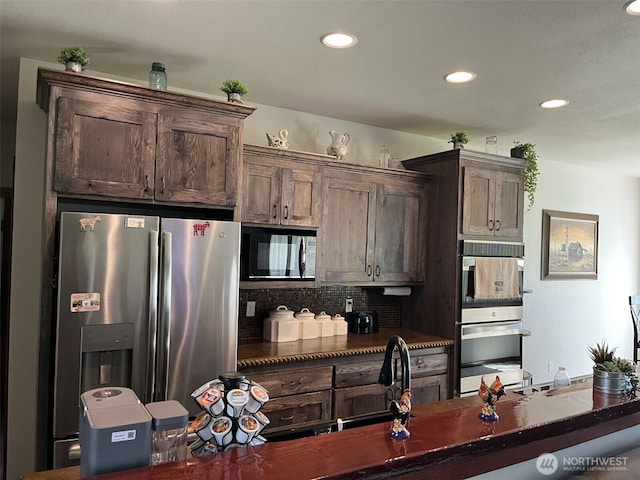 137 La Due Cemetery Rd, Onalaska, WA 98570 - kitchen with stainless steel appliances, dark countertops, tasteful backsplash, recessed lighting, and dark brown cabinets