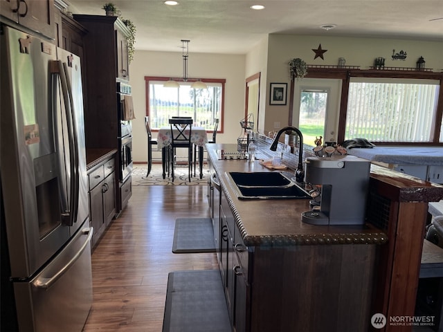 137 La Due Cemetery Rd, Onalaska, WA 98570 - kitchen featuring appliances with stainless steel finishes, a sink, dark countertops, recessed lighting, and dark brown cabinetry