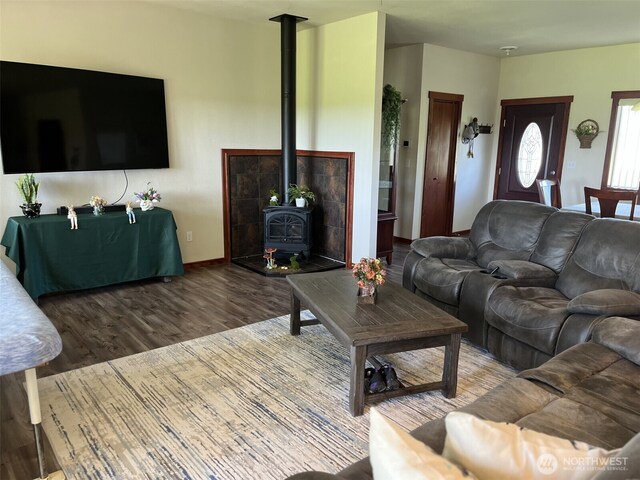137 La Due Cemetery Rd, Onalaska, WA 98570 - living room featuring a wood stove, wood finished floors, and baseboards