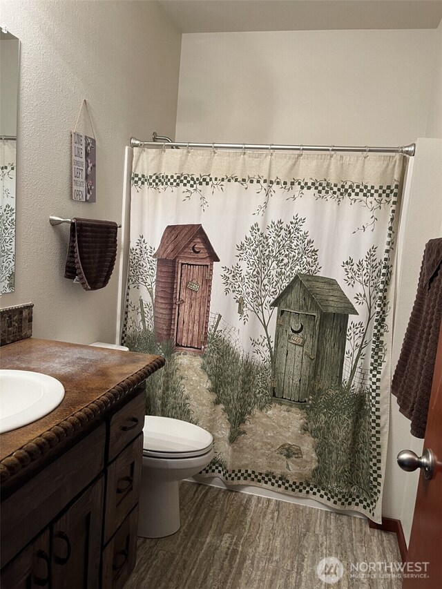 137 La Due Cemetery Rd, Onalaska, WA 98570 - full bath with wood finished floors, vanity, toilet, and curtained shower