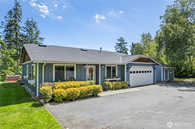1555 Silver Lake Rd, Oak Harbor, WA 98277 - view of front of house with a shingled roof, board and batten siding, a garage, and a front yard