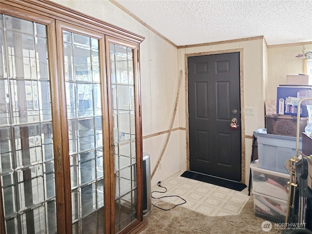 3516 Harrison Ave Unit H, Centralia, WA 98531 - entryway with ornamental molding, a textured ceiling, and tile patterned floors