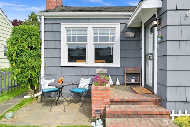 1060 Peace Portal Dr, Blaine, WA 98230 - doorway to property featuring a chimney, fence, and a patio