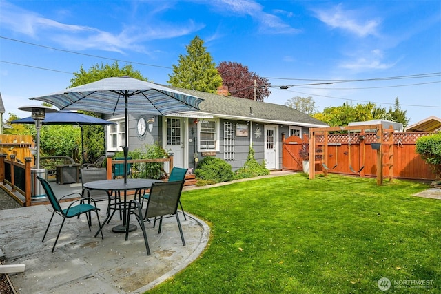 1060 Peace Portal Dr, Blaine, WA 98230 - back of property with a gate, a patio, a chimney, outdoor dining space, and a shingled roof