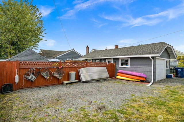 1060 Peace Portal Dr, Blaine, WA 98230 - back of house with fence, a shingled roof, and a chimney