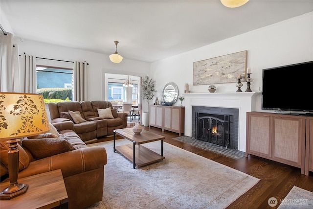 3708 N Madison St, Tacoma, WA 98407 - living area featuring wood finished floors, a fireplace with flush hearth, and a chandelier