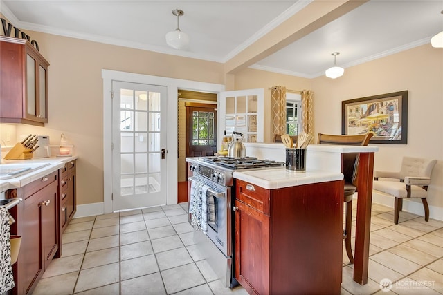 3708 N Madison St, Tacoma, WA 98407 - kitchen featuring stainless steel gas range, dark brown cabinets, light tile patterned floors, tile countertops, and crown molding