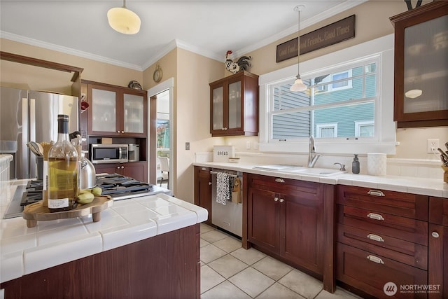 3708 N Madison St, Tacoma, WA 98407 - kitchen featuring stainless steel appliances, a sink, decorative light fixtures, ornamental molding, and light tile patterned flooring