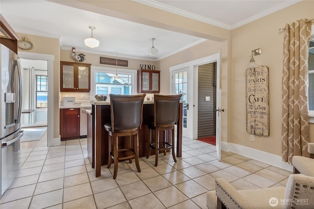 3708 N Madison St, Tacoma, WA 98407 - kitchen with stainless steel refrigerator with ice dispenser, a breakfast bar area, glass insert cabinets, light countertops, and light tile patterned floors