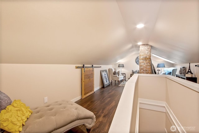 3708 N Madison St, Tacoma, WA 98407 - bedroom with a barn door, dark wood-type flooring, vaulted ceiling, and baseboards