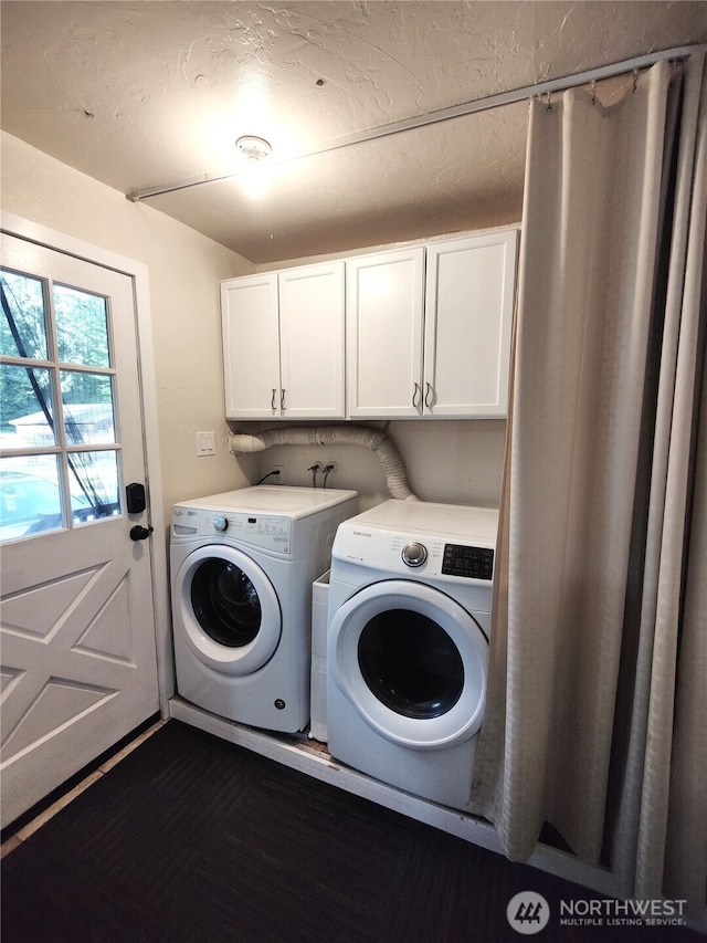laundry area featuring washing machine and dryer and cabinet space