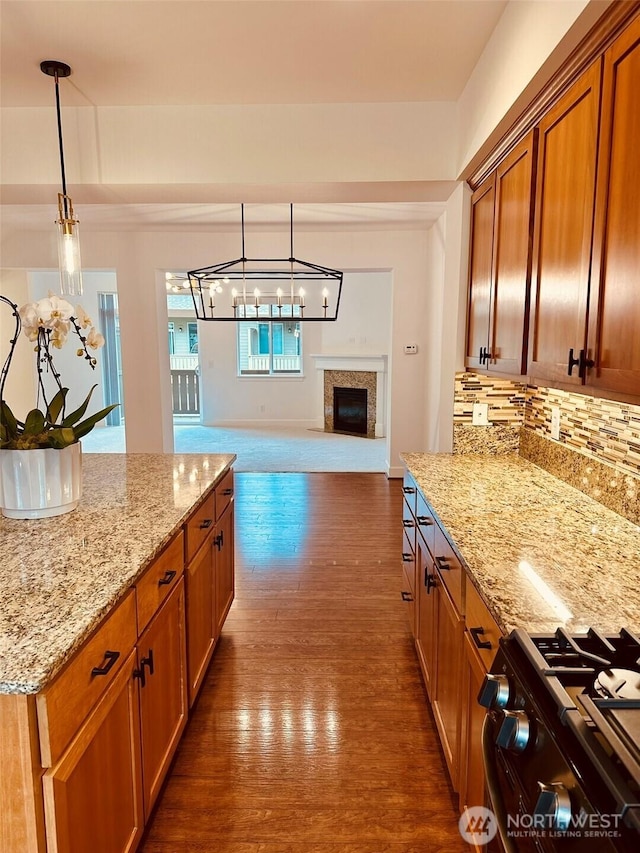 4660 NE 3rd Ct Unit J3, Renton, WA 98059 - kitchen with range with gas cooktop, dark wood-style floors, backsplash, open floor plan, and light stone counters