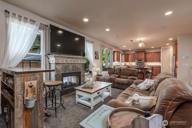 1715 131st St S, Tacoma, WA 98444 - living area with recessed lighting, a tiled fireplace, and dark colored carpet