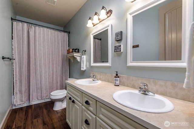 1715 131st St S, Tacoma, WA 98444 - full bath featuring double vanity, toilet, and wood finished floors