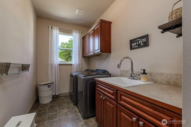 1715 131st St S, Tacoma, WA 98444 - washroom with cabinet space, independent washer and dryer, baseboards, and stone finish floors