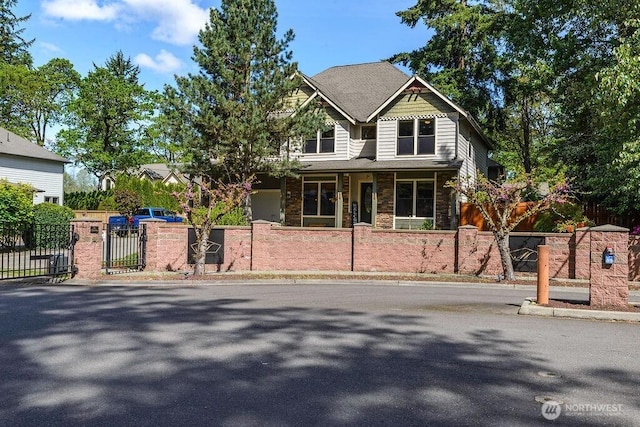 1715 131st St S, Tacoma, WA 98444 - view of front facade featuring a fenced front yard, stone siding, covered porch, and a gate